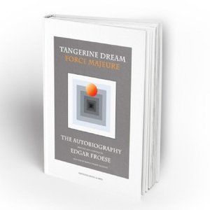 The English hardback of Force Majeure, standing at an angle. The grey cover reads TANGERINE DREAM, FORCE MAJEURE, THE AUTOBIOGRAPHY, EDGAR FROESE, with an orange ball floating above a set of nested squares