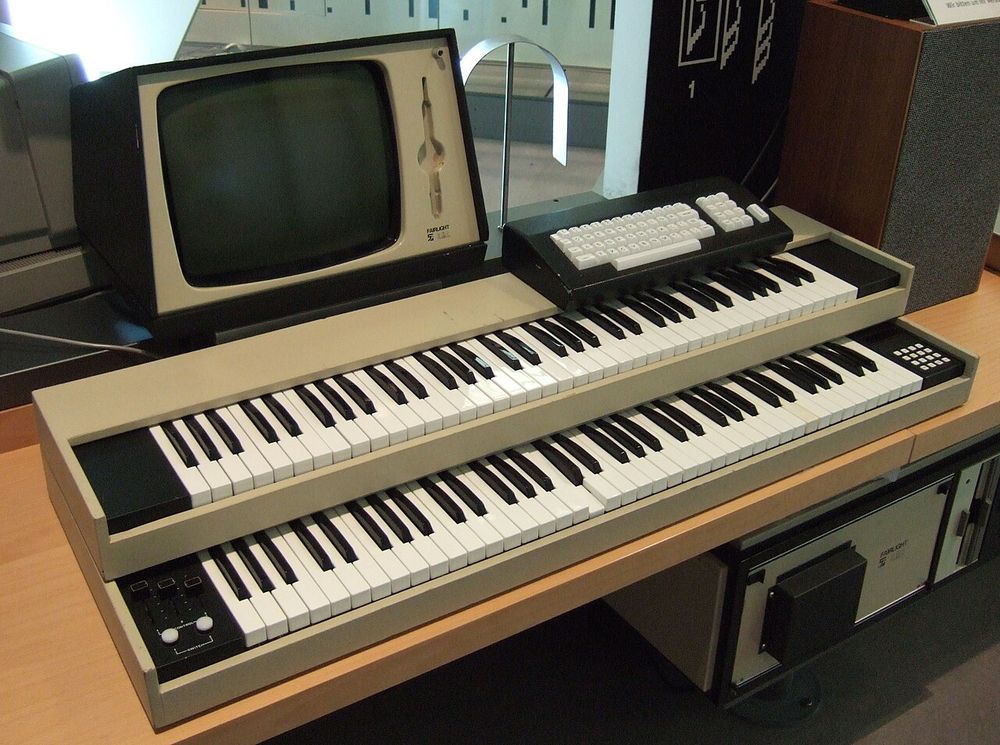 A Fairlight CMI. A light pen sits in its holder beside the monitor, with two keyboards and a typewriter keyboard in front
