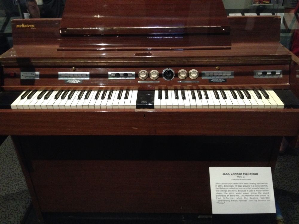 A Mellotron in a wooden cabinet, two keyboards side by side under a row of switches and knobs